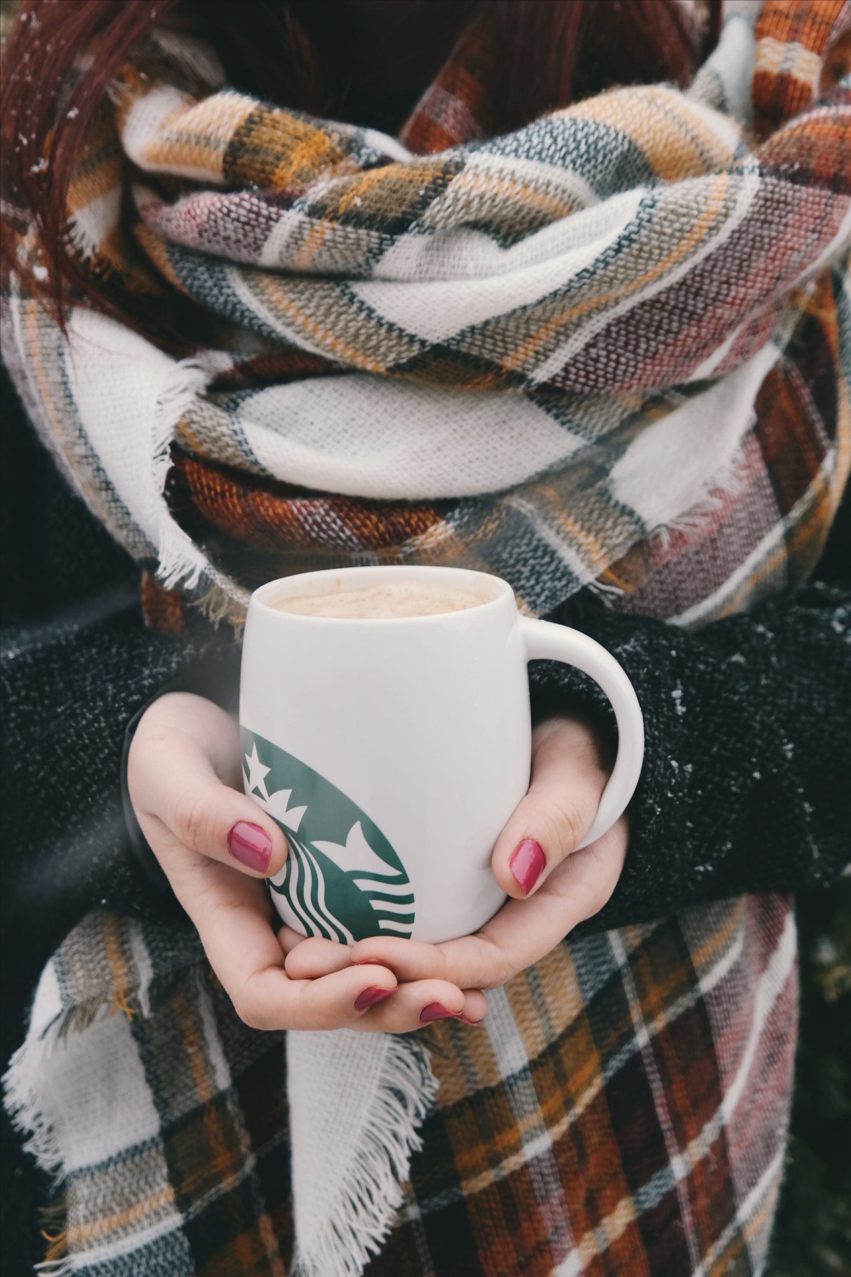 woman holding a starbucks mug