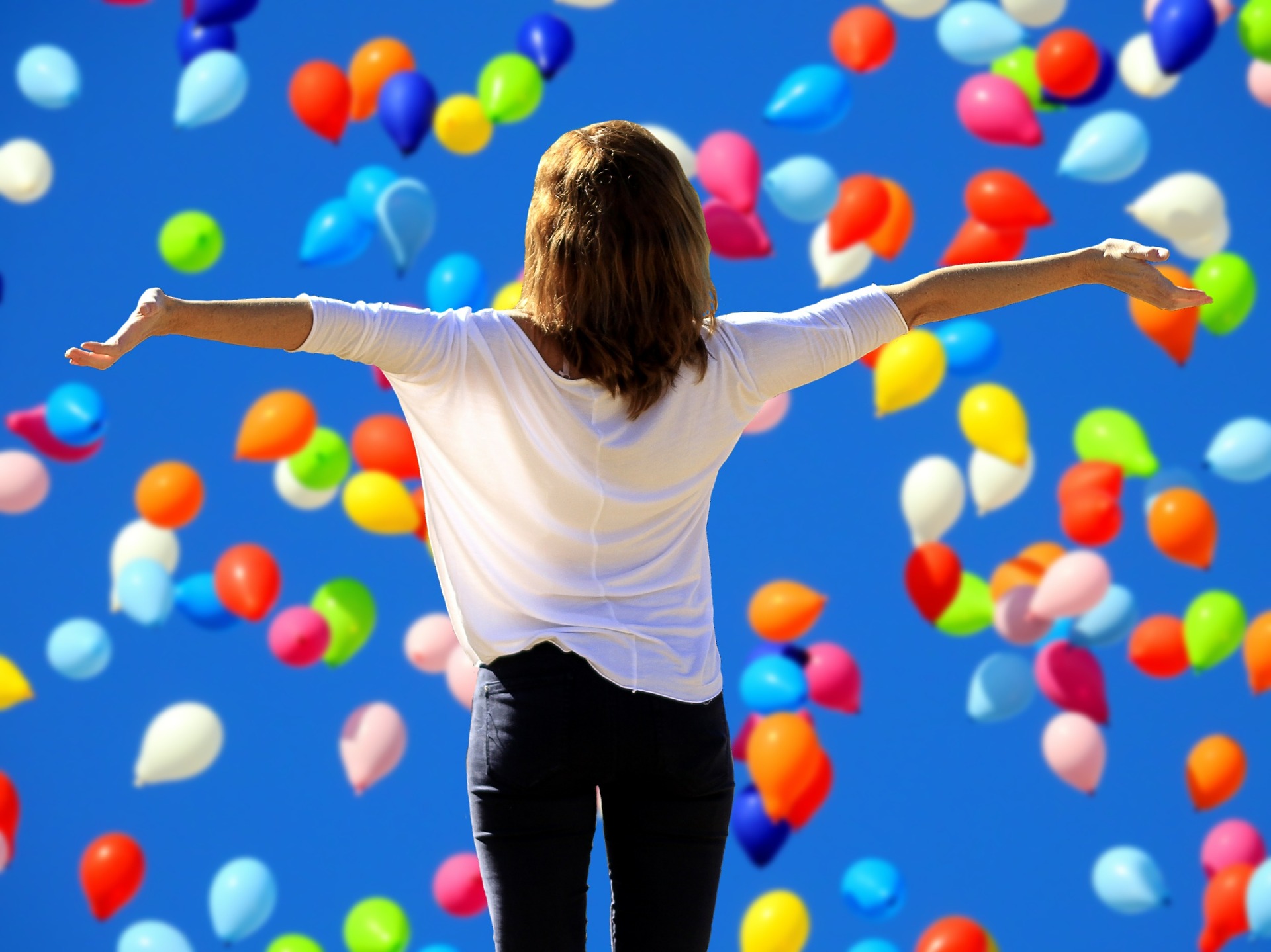 woman free amongst balloons